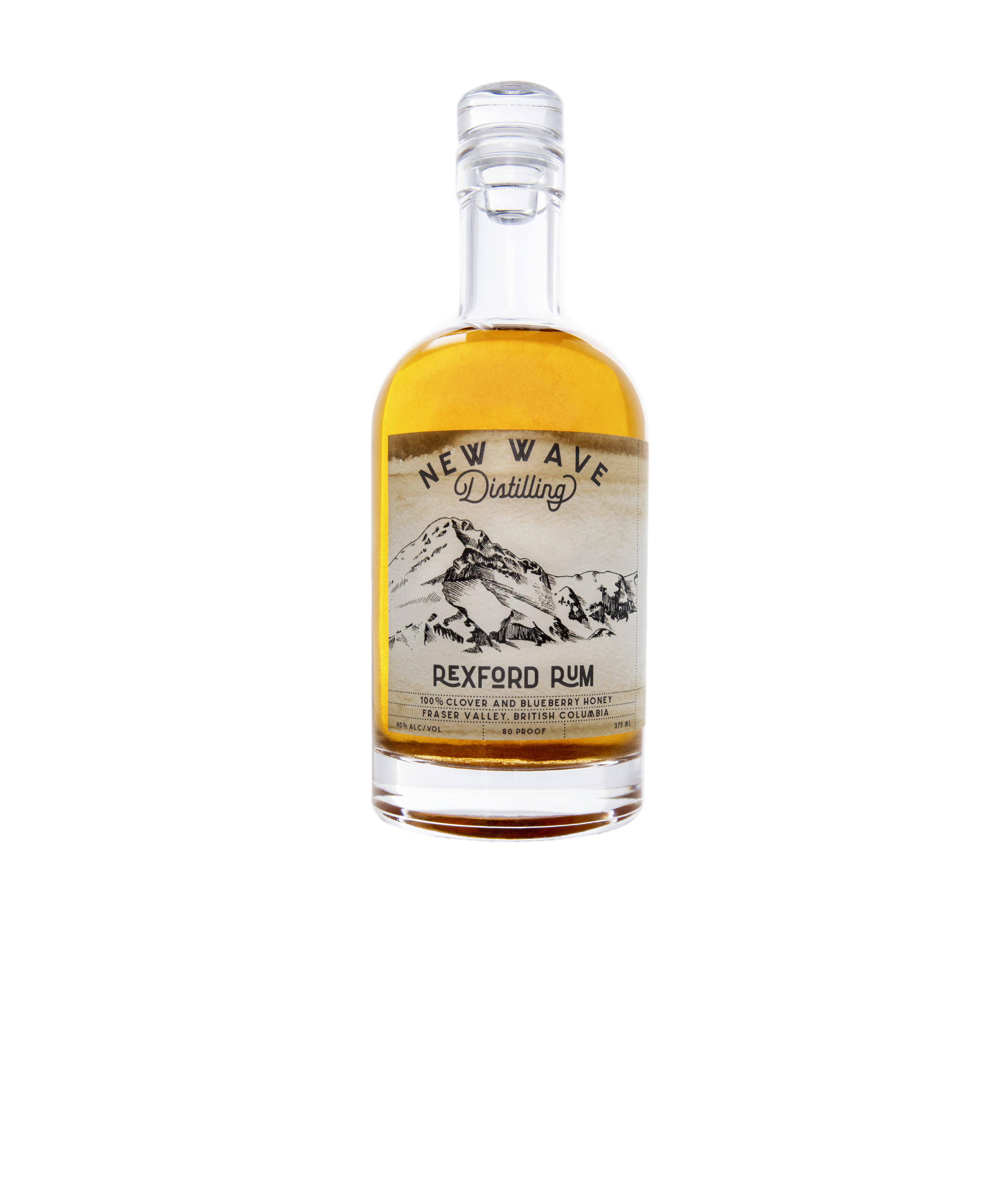 A clear glass bottle of New Wave Distilling REXFORD RUM with a mountain landscape label showing snowy peaks and trees, containing amber-colored rum.